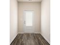 Welcoming entryway with wood-look flooring and a glass-paneled front door at 471 Prescott Way, Villa Rica, GA 30180
