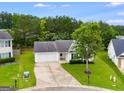 Birds eye view of a single story home with a two car garage, in a neighborhood with mature trees at 102 Natalie Ct, Dallas, GA 30157