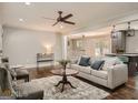 Cozy living room with a ceiling fan and seamless transition to the kitchen at 2739 Flagstone Se Dr, Atlanta, GA 30316