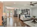 Open-concept living room with hardwood floors, ceiling fan, and seamless transition to the kitchen at 2739 Flagstone Se Dr, Atlanta, GA 30316