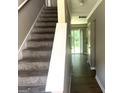 Inviting hallway with a staircase leading to the upper level and a view of the backyard at 6300 Creekford Ln, Lithonia, GA 30058