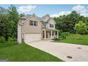 Beautiful two-story home boasts a well-kept lawn and attached garage, blending brick and siding details at 5662 Valley Loop, Fairburn, GA 30213