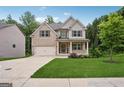 Charming two-story home with brick and siding, a well-manicured lawn, and an attached two-car garage at 5662 Valley Loop, Fairburn, GA 30213