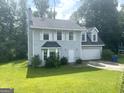 Charming two-story home with a well-maintained lawn and attached two-car garage at 6650 Smoke Ridge, Atlanta, GA 30349