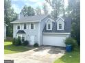 Charming two-story home with a well-maintained lawn and attached two-car garage, offering curb appeal at 6650 Smoke Ridge, Atlanta, GA 30349
