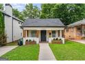 Charming home with a well-manicured lawn, inviting front porch, and a classic exterior at 995 Lena Nw St, Atlanta, GA 30314