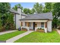 Charming home with a well-manicured lawn, inviting front porch, and a classic exterior at 995 Lena Nw St, Atlanta, GA 30314