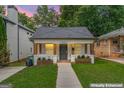 Charming home with a well-manicured lawn, inviting front porch, and a classic exterior, virtually enhanced for appeal at 995 Lena Nw St, Atlanta, GA 30314