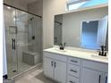 Modern bathroom with tiled shower, glass door, and dual sink vanity at 422 Cantrell Drive, Dallas, GA 30157