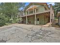 Expansive two-story home with a spacious wooden deck, lower-level access, and a covered parking area at 6220 Petersburg Rd, Fairburn, GA 30213