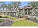 Exterior view featuring an elegant entryway with brick steps and professionally landscaped gardens at 375 Darren Dr, Fayetteville, GA 30215
