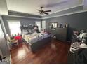 Spacious main bedroom featuring beautiful hardwood floors and a vaulted ceiling with a ceiling fan at 2119 Amherst Se Trl, Conyers, GA 30094