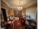A spacious dining room with hardwood floors and a large window for natural light at 2119 Amherst Se Trl, Conyers, GA 30094