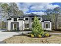 Imposing two-story home with a white brick exterior, dark trim, and a circular driveway at 4090 Sandy Lake Dr, Lithonia, GA 30038