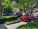 Parking lot with various vehicles, surrounded by lush greenery, and trees at 17 Brittany Ne Way, Atlanta, GA 30324