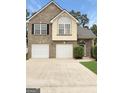 Beautiful home featuring a brick exterior, two-car garage, arched entry, and manicured landscaping at 120 Hawken Trl, Mcdonough, GA 30253
