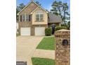 Inviting two-story home with brick accents, a two-car garage, and verdant lawn at 120 Hawken Trl, Mcdonough, GA 30253