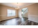 Bright dining room with modern lighting, large window, and stylish dark wood flooring at 1849 Wanda Way, Ellenwood, GA 30294