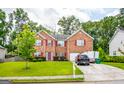 Charming brick home with a well-kept lawn, driveway, and mature trees in a desirable location at 1849 Wanda Way, Ellenwood, GA 30294