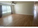 Bright living room with laminate flooring, a ceiling fan, and lots of natural light at 14104 Fairington Ridge Cir, Lithonia, GA 30038