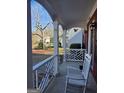 Inviting front porch with white railing and rocking chair offers a relaxing outdoor space at 5725 Lake Windsor Pkwy, Buford, GA 30518