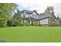 Stunning two-story home with a well-manicured lawn and a charming craftsman-style front porch at 383 Beaumont Farms Dr, Sharpsburg, GA 30277