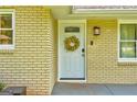 Close-up of the front door adorned with a decorative wreath on a brick facade at 1848 Winthrop Se Dr, Atlanta, GA 30316