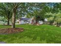 Well-maintained home featuring a green lawn and mature trees in a suburban setting at 905 Creekmore Ln, Loganville, GA 30052