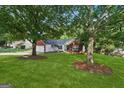 Attractive single-story home with a lush lawn and mature trees shading the front yard at 905 Creekmore Ln, Loganville, GA 30052