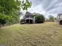 Expansive backyard featuring a two-story home with a screened porch, perfect for outdoor enjoyment and relaxation at 237 Shockley Way, Dallas, GA 30157
