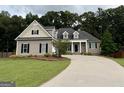 Charming home with manicured lawn, inviting entrance, and beautiful landscaping, offering great curb appeal at 237 Shockley Way, Dallas, GA 30157