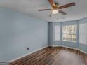 Bright bedroom with wood-look floors, a bay window, and neutral window coverings at 424 Browning Field Way, Hampton, GA 30228