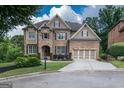 Beautiful two-story home with well-kept lawn, professional landscaping, and a two-car garage at 6248 Sunshine Cove Ln, Buford, GA 30518