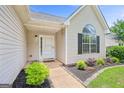 Inviting entryway with a well-lit porch and neatly landscaped garden beds at 147 Calico Loop, Grantville, GA 30220