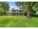 Stunning two-story home with a beautiful lawn and mature trees at 955 Landmark Dr, Sandy Springs, GA 30342