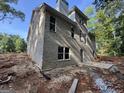 Rear view of new construction features large windows and a patio, perfect for enjoying the private backyard at 3019 Beverly Ct, Mcdonough, GA 30252