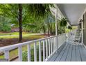 Relax on this inviting front porch with views of a lush green neighborhood street at 103 Everhill, Peachtree City, GA 30269