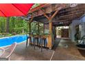 Poolside bar and lounge area for effortless relaxation and entertaining at 103 Everhill, Peachtree City, GA 30269