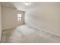 Bright bedroom featuring neutral carpet and a large window at 3511 Brockenhurst Dr, Buford, GA 30519