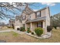 This two-story brick home has a two-car garage, landscaped yard and inviting covered front porch at 3225 Alhambra Cir, Hampton, GA 30228