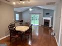 Inviting living room with an open floor plan, wood floors, brick fireplace, and bar-height counter at 581 N Fairfield Dr, Peachtree City, GA 30269