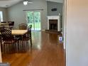 Bright living room with hardwood floors, a fireplace, and sliding glass doors that lead to a backyard at 581 N Fairfield Dr, Peachtree City, GA 30269