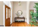 Elegant foyer showcasing hardwood floors, decorative front door, and stylish console table at 450 Riverwalk, Mcdonough, GA 30252