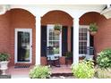 Welcoming front porch with rocking chairs and decorative hanging plants at 405 Mallory Cir, Loganville, GA 30052