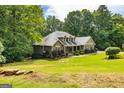Beautiful house surrounded by lush trees and a well-maintained lawn at 500 Barrington Farms Pkwy, Sharpsburg, GA 30277