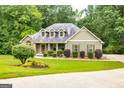 Stunning home with well-manicured landscaping, mature trees, and a welcoming front entrance at 500 Barrington Farms Pkwy, Sharpsburg, GA 30277