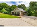 Home exterior featuring an attached garage and well-groomed landscaping at 500 Barrington Farms Pkwy, Sharpsburg, GA 30277