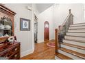 Beautiful foyer showcasing hardwood floors, staircase, and natural light at 4595 Carriage Walk Ln, Cumming, GA 30040