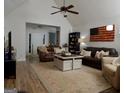 Spacious living room featuring vaulted ceilings, wood floors, and comfortable seating at 219 Brown Branch Rd, Locust Grove, GA 30248