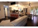 A bright, open kitchen and living area with stainless steel appliances and eat-in counter at 85 Pine Haven Dr, Carrollton, GA 30116